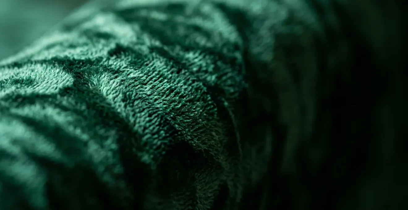 Luxurious crushed velvet upholstery fabric close-up showing rich texture and pile structure in sophisticated lighting