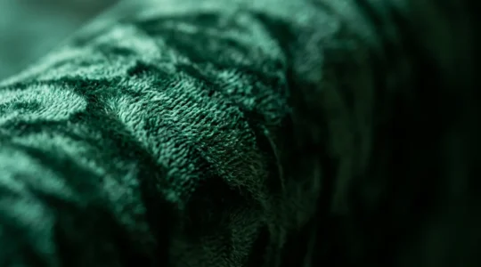 Luxurious crushed velvet upholstery fabric close-up showing rich texture and pile structure in sophisticated lighting